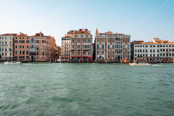 The Gothic Venetian Buildings and local water transport on the Grand Canal in Venice, Italy.  
