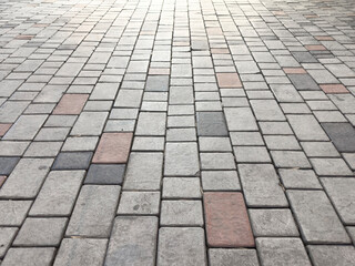 Fototapeta premium Sidewalk tiles. Closeup of paving slabs background. Street paving slabs. Cement block of the road. Cement brick squared stone floor background.