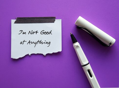 Pen and stick note on purple background with handwritten text - I&rsquo;m Not Good at Anything - concet of self limiting beliefs, everyone possesses unique talents and must find out their strengths