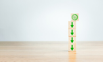Reduce CO2 emission and its impact on nature concept. Carbon dioxide icon and arrow are falling on wooden box.Renewable energy-based green businesses can limit climate change and global warming.