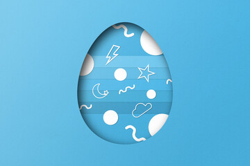 Light blue paper cut to form an Easter egg pattern.