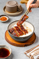 Unagi donburi It consists of a donburi type large bowl filled with steamed white rice, and topped with fillets of eel (unagi) grilled in a style known as kabayaki, similar to teriyaki.