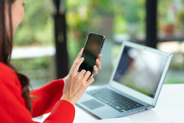 Happy business woman talking on mobile phone while analyzing weekly schedule in her notebook