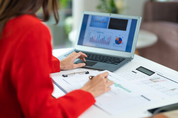 Woman working at home office hands on keyboard close-up