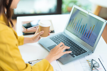 Woman working at home office hands on keyboard close-up