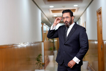 Indian businessman wearing eyeglasses and giving expression.