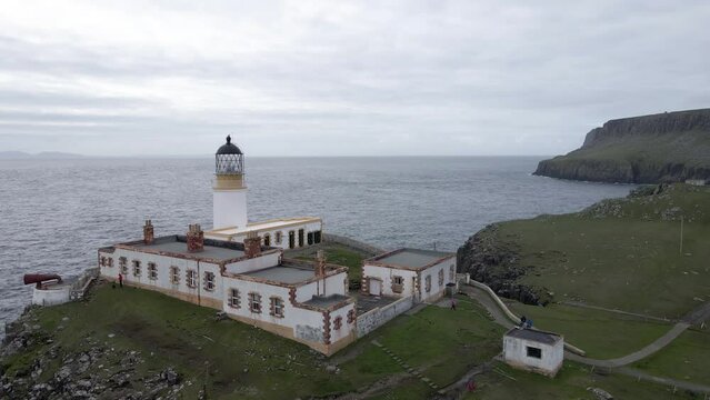 4k aerial drone footage zooming out neist point cliffs lighthouse in scotland uk