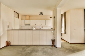 an empty kitchen and dining area in a house or apartment with white walls, wood trims, and flooring