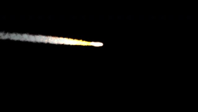 A medium-sized meteor flying across the sky at a distance. The shot is 4K and comes with and without an alpha channel