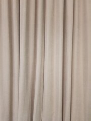 Fototapeta premium Beige abstract curtains, fabric background