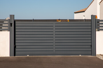 Aluminum portal sliding grey large car gate of modern house in street view