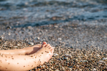 Bare feet of a small child on the beach