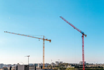 Fototapeta na wymiar Construction crane working on large construction site