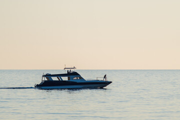 Fototapeta na wymiar Silhouette of a boat on the open sea