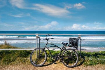A bicycle against the parapet on the walking path at North Cronulla Beach in Sydney, NSW,...