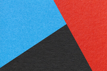 Texture of craft red, black and blue shade color paper background, macro. Structure of vintage abstract cardboard