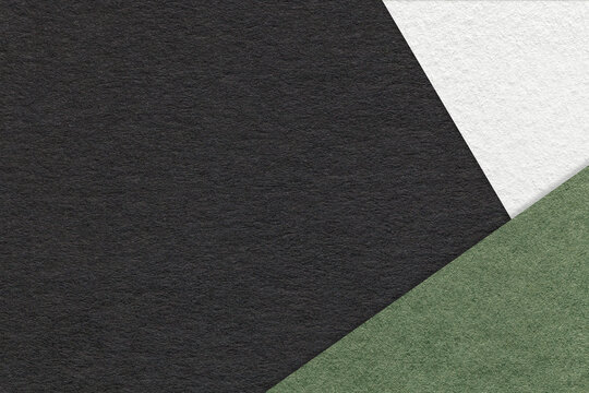 Texture of craft black color paper background with white and green border. Vintage abstract cardboard.