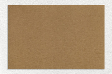 Texture of craft brown color paper background with white border, macro. Vintage dense kraft beige cardboard