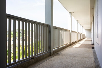 Modern corridor walkway with a fence railing for safety.