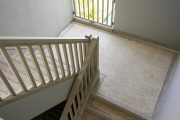Modern pebble stone staircase with railing handle for safety.