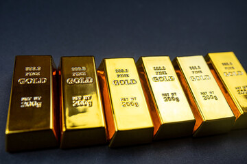 Stack of golden bars isolated on black background