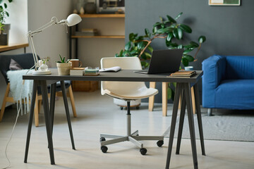 Horizontal image of workplace with laptop for online work in the living room at home