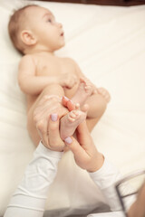 Female Massage Therapist doing baby massage for foot little infant baby child
