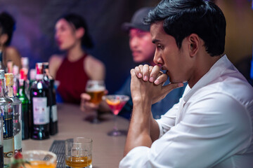 Asian depression man feeling heart broken and drinking beer in a bar. 