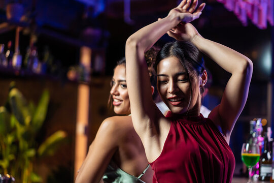Asian beautiful women having fun, meeting each other in bar restaurant. 