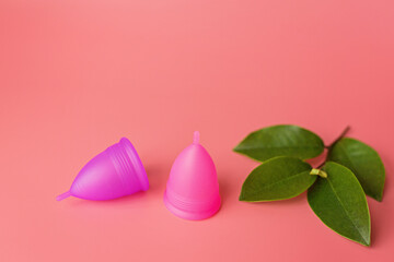Menstrual cups on pink background. Alternative feminine hygiene product during the period. Women health concept. Copy space. Eco friendly concept, zero waste product. mockup, template