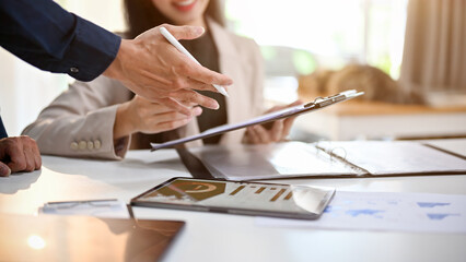 Fototapeta premium Businesspeople are in the financial meeting, analyzing financial data on report. cropped image