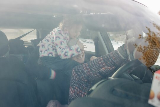 Mother And Daughter Playing And Laughing In The Car