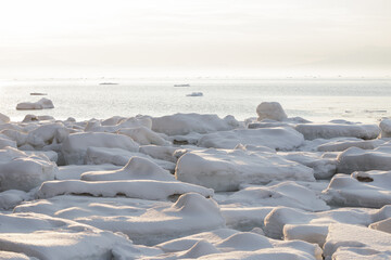 Sea drift ice piled up on winter beach