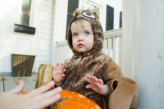 Toddler boy looks into distance while dressed up in Halloween costume