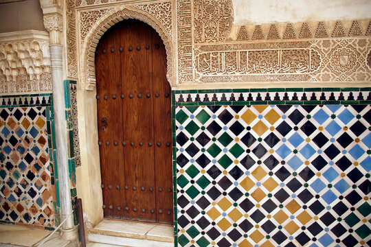 Islamic art tiled wall and door in the Alhambra Palace,