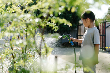 Girl watering plants in garden