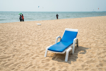 Fototapeta na wymiar Sun loungers or canvas chairs on sand beach at the sea for relax on summer holiday.