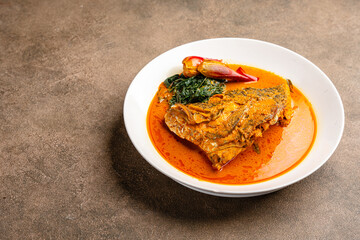 snapper curry fish head (gulai kepala ikan kakap) from padang, west sumatera, indonesia.