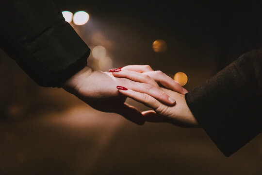 Closeup of white hands together in love in countryside