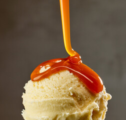 caramel sauce flowing on vanilla ice cream