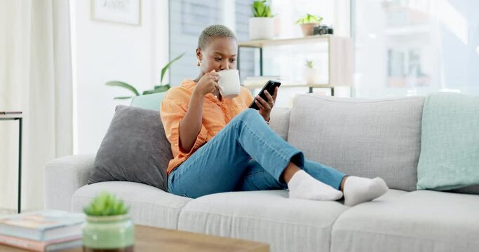 Coffee, relax and black woman with phone on sofa in home living room, texting or social media. Drinking tea, cellphone and happy female with mobile smartphone for web scrolling and internet browsing.