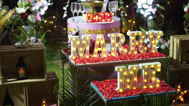 Wedding night decoration made of lights with the inscription marry me