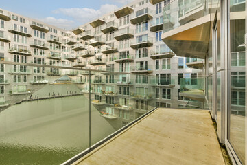 an outside area with buildings and water in the fore - lit part of the photo, taken from inside to...