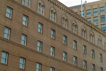 Naklejka premium Modern apartment complex building for residential or comercial real estate with many visible rows of windows and ladder