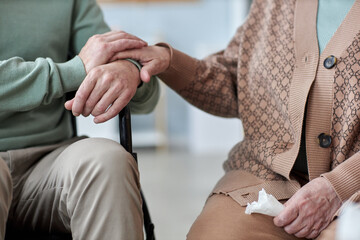 Close up of unrecognizable senior couple holding hands during therapy session