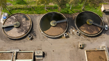 Aerial view of the tanks of a sewage and water treatment plant enabling the discharge and re-use of waste water. It's a sustainable water recycling with treatment plant.