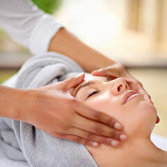 Letting experienced hands ease away the stress. a young woman enjyoing a massage at the day spa.