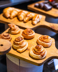 Close up freshly baked pastry goods on display in bakery shop. Selective focus