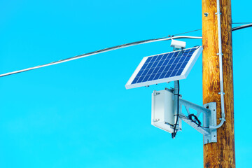 Solar Panel and Auxiliary Equipment on a Wooden Pole