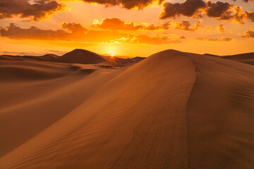 Beautiful sunset over the sand dunes in the Arabian Empty Quarter Desert. UAE